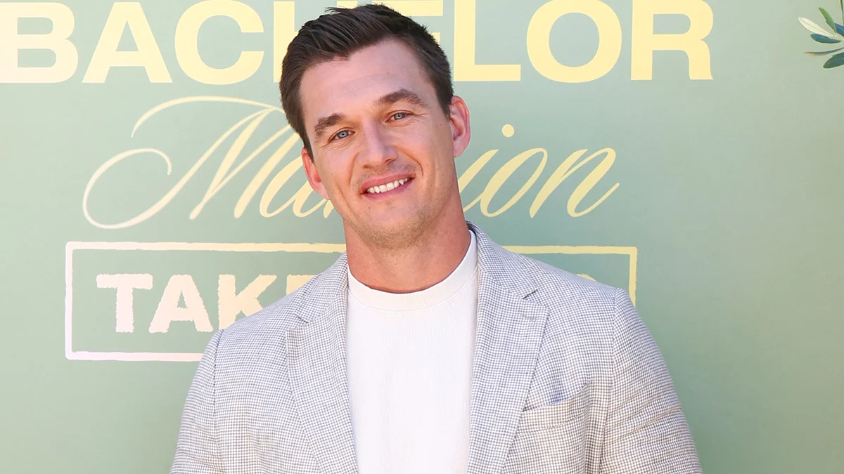 File photo of Tyler Cameron in a gray suit at a Bachelor Nation event
