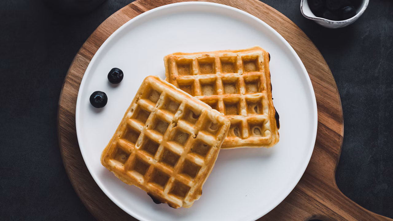 Savory golden waffles topped with herbs and served for brunch