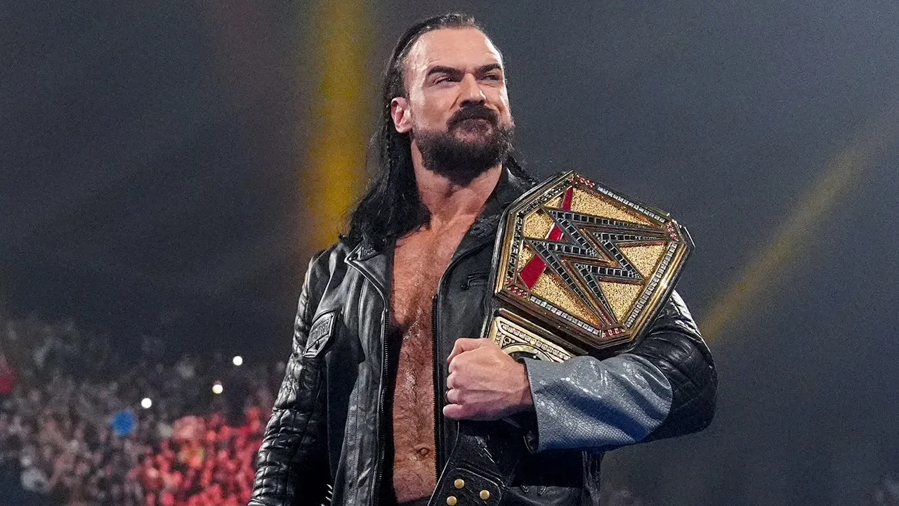 Drew McIntyre holds the WWE championship while entering the ring at Wembley