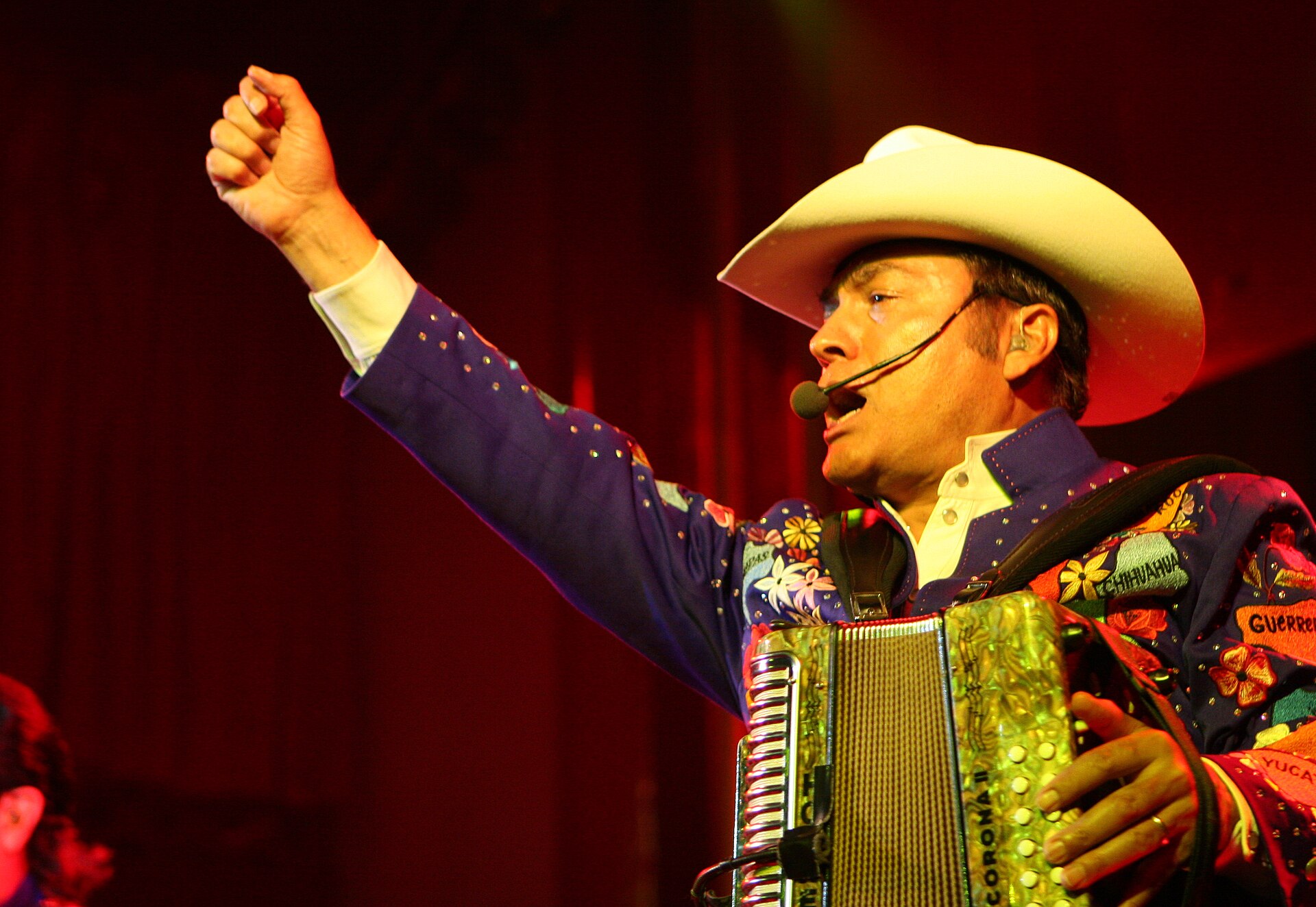 Members of Los Tigres del Norte performing on stage with accordion and guitars at Sala Apolo in Barcelona in 2008