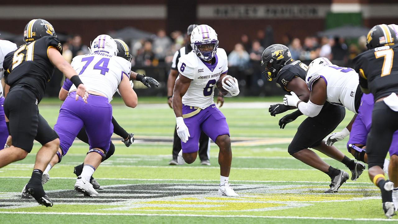James Madison ball carrier Kaelon Black runs through Appalachian State defenders during a previous meeting at Kidd Brewer Stadium.