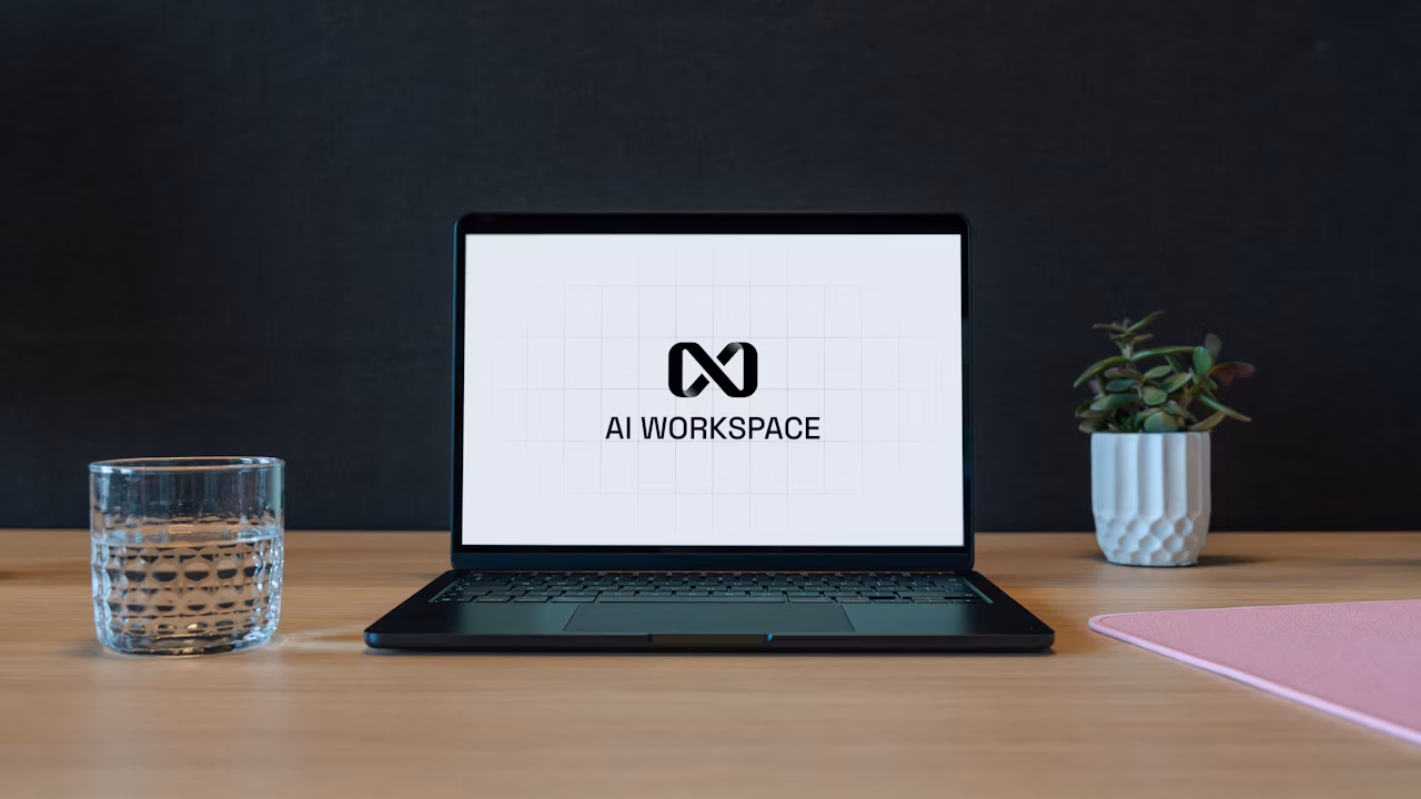 A person using a laptop displaying an AI workspace interface at a modern desk