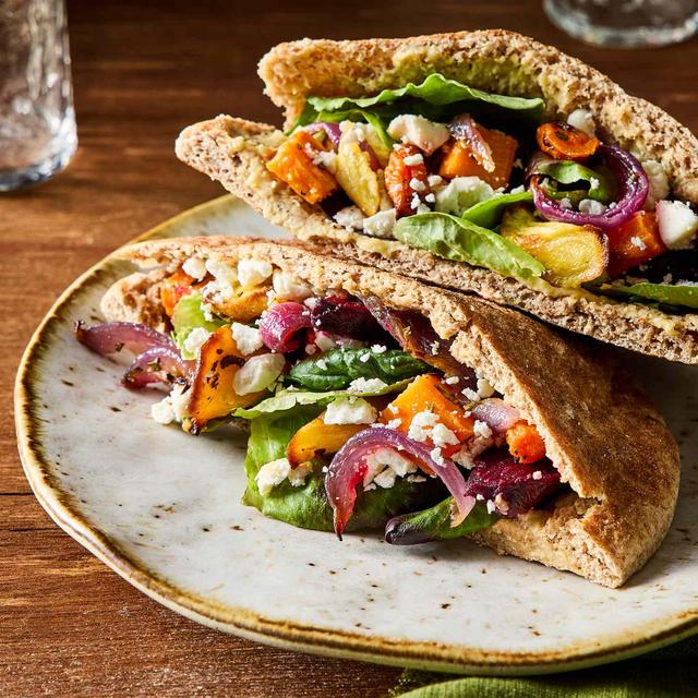 A prepared serving of roasted vegetable hummus pita