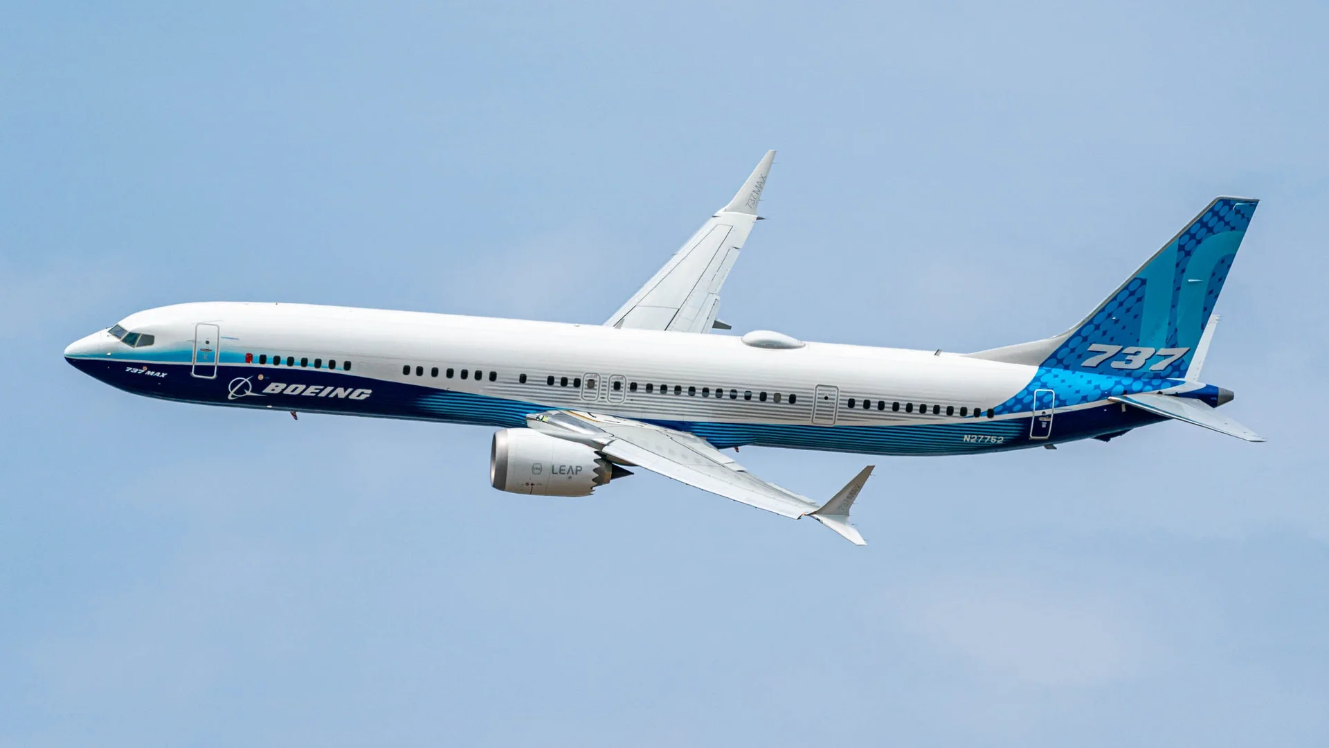 Boeing 737 MAX test aircraft in flight in blue-and-white livery
