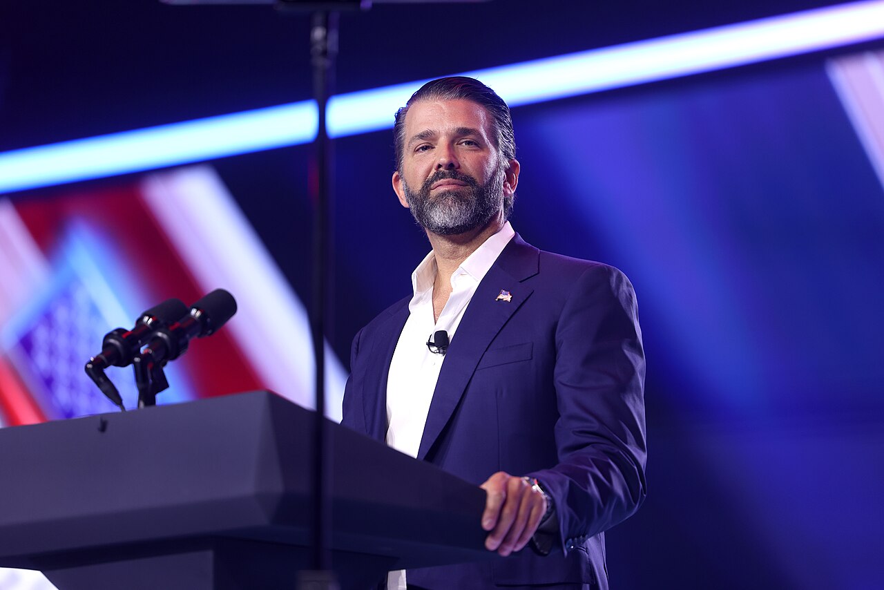 Donald Trump Jr. speaking with attendees at the 2025 AmericaFest conference at the Phoenix Convention Center in Arizona