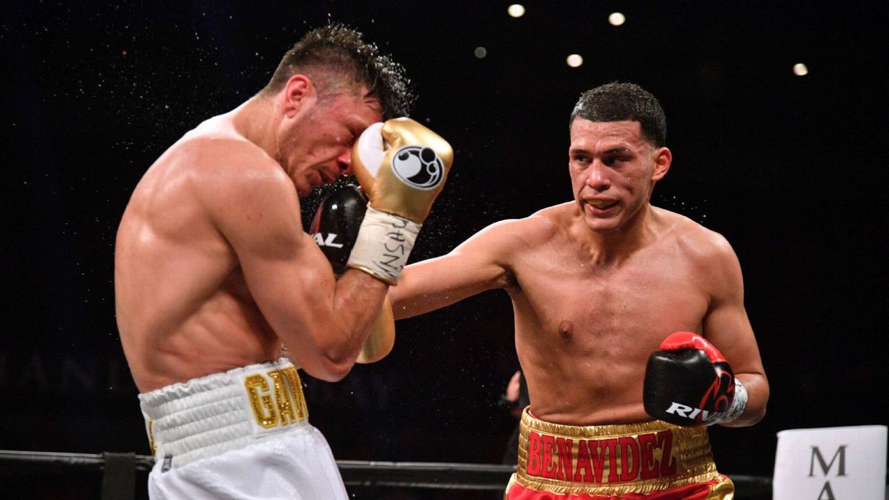 David Benavidez trades punches with Ronald Gavril during a super middleweight title fight.