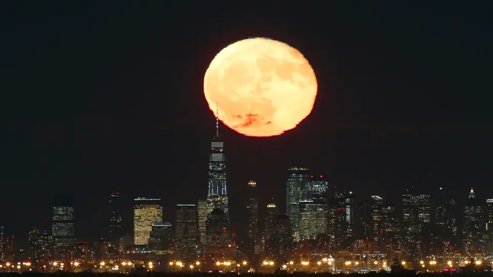 An orange Hunter's Moon rises behind One World Trade Center in a file photograph