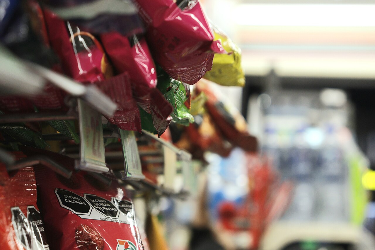 Bags of packaged snack foods hanging on a convenience store rack