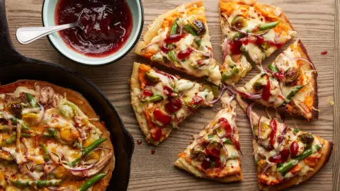 thanksgiving leftover pizza with gravy and cranberry drizzle as a finished dish ready to serve.
