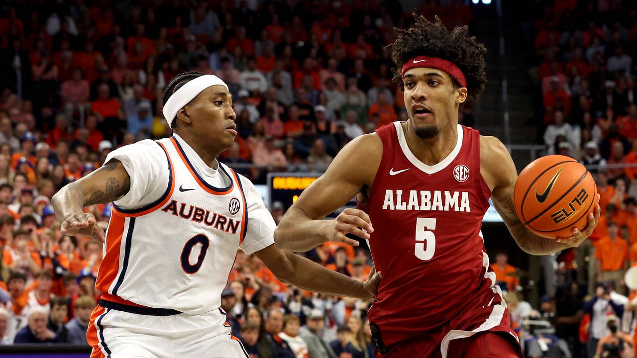 Alabama forward Amari Allen handles the ball while Auburn guard Tahaad Pettiford defends during a 2026 rivalry game