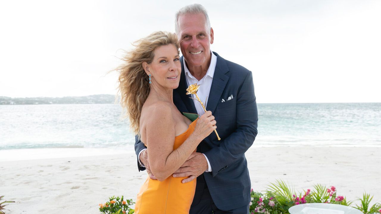 Peg Munson and Mel Owens pose together on a beach during The Golden Bachelor finale.