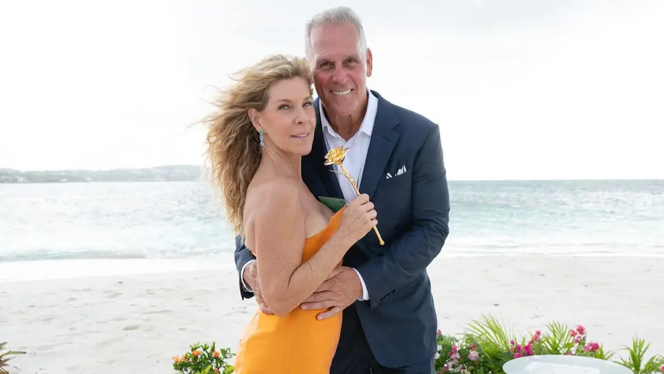 Peg Munson and Mel Owens pose together on a beach during The Golden Bachelor finale.
