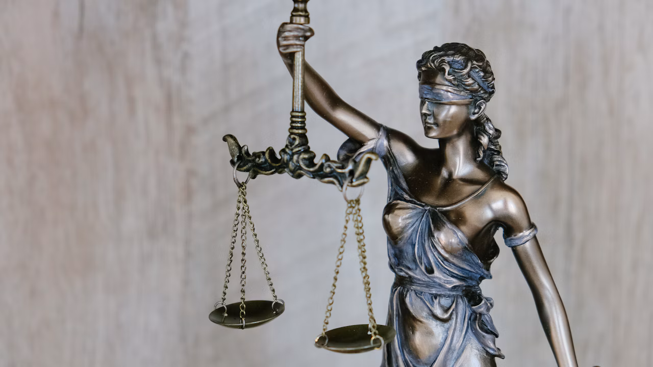 Illustrative photograph of a blindfolded Lady Justice statue holding scales; not a photograph of the Hope Florida proceedings.