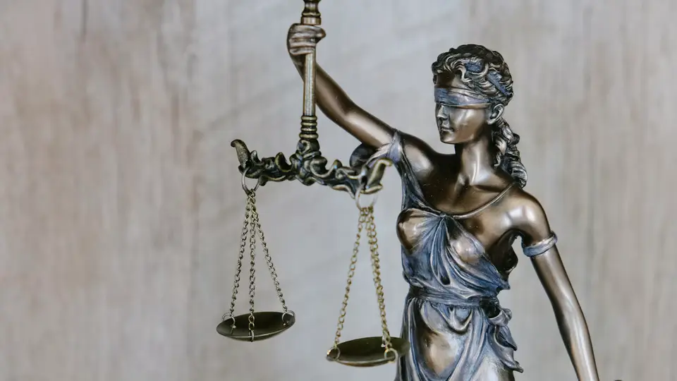 Illustrative photograph of a blindfolded Lady Justice statue holding scales; not a photograph of the Hope Florida proceedings.
