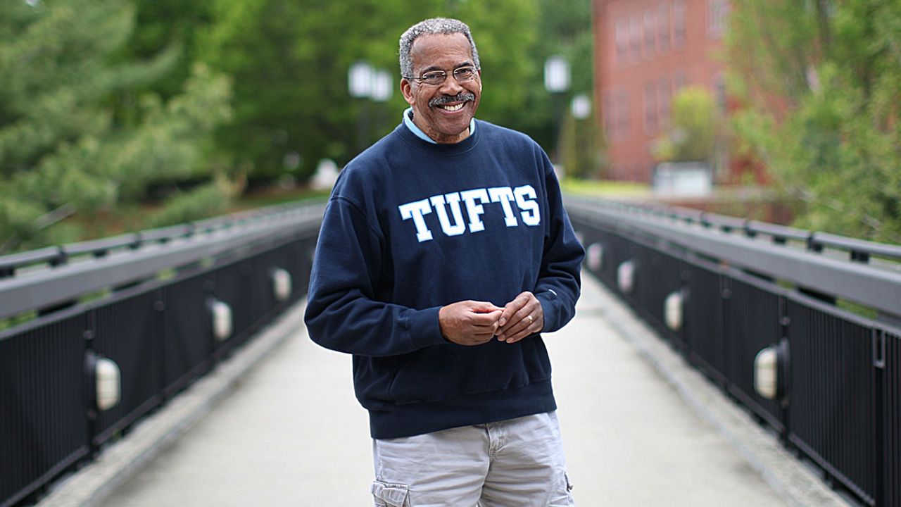 Former WCVB anchor Jim Boyd stands on a bridge at Tufts University after returning to college.