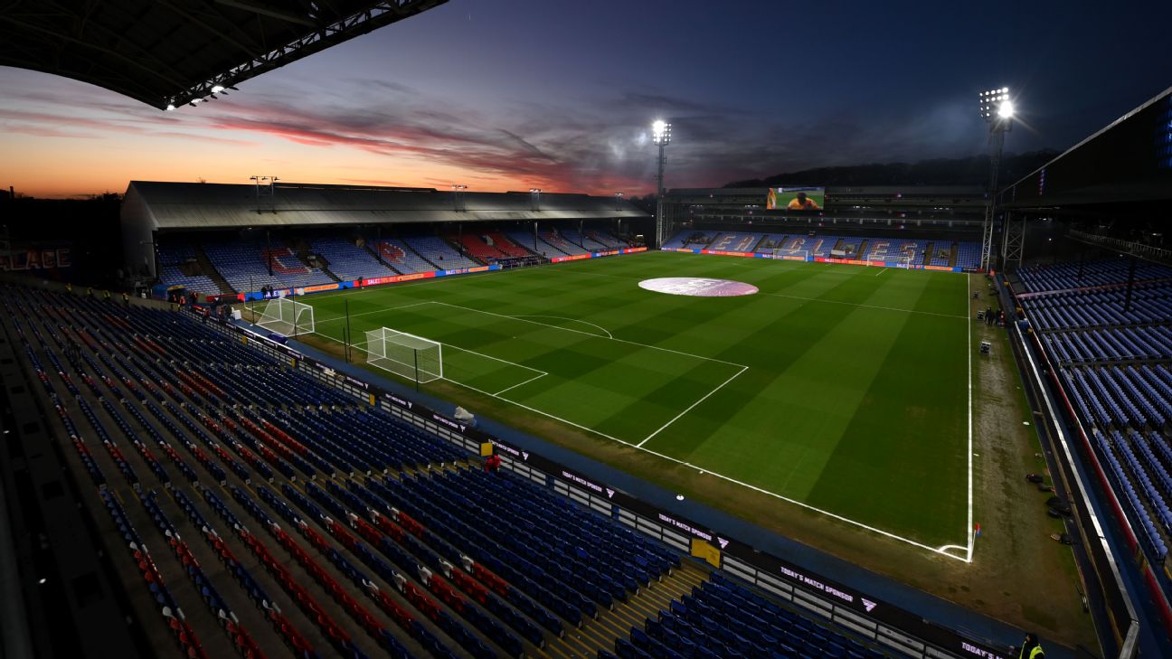 Selhurst Park in London under floodlights before a football match.