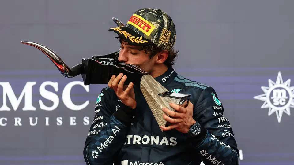 Kimi Antonelli kisses the winner's trophy after the 2026 United States Grand Prix in Austin, where Sophie Cunningham waved the finish flag