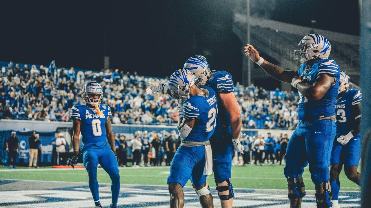 Memphis Tigers football players celebrate together during a home game at Simmons Bank Liberty Stadium