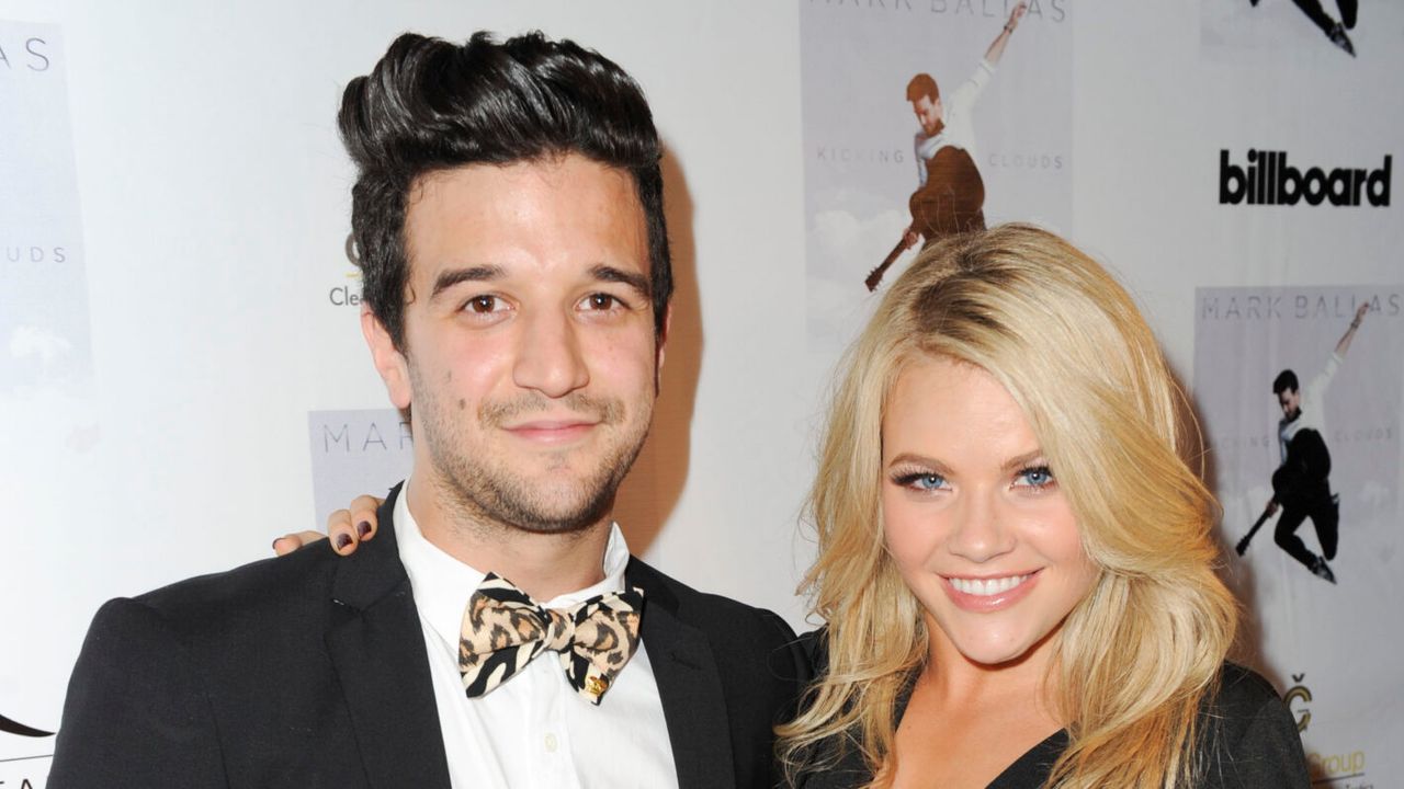 Mark Ballas and Witney Carson pose together at an event.