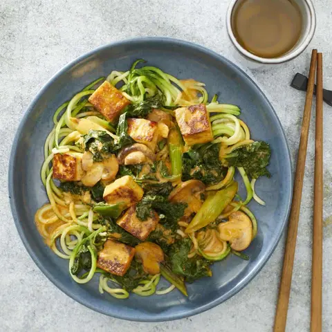 A prepared serving of tofu curry with zucchini noodles