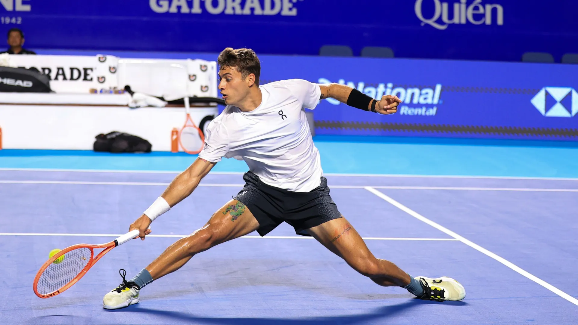 Flavio Cobolli stretches for a return during the 2026 Acapulco final; illustrative archive image, not the Lyon match