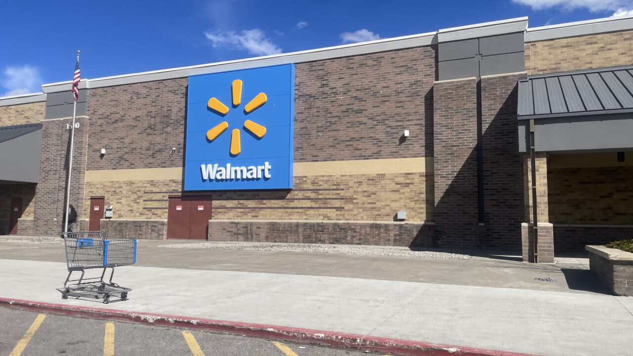 The exterior of a Walmart store with the retailer's blue-and-yellow sign above the entrance