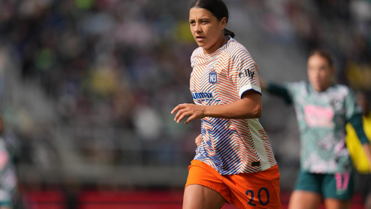 Club-issued file photograph of a Gotham FC player in a patterned white jersey and orange shorts; not a photograph from the Oct. 25 Orlando match.