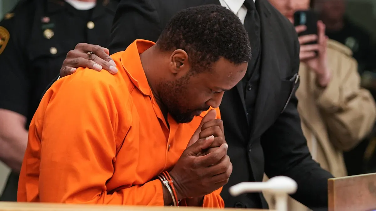 Rodney Hinton Jr. in an orange jail uniform during a May 2025 court appearance; file image, not Friday’s verdict