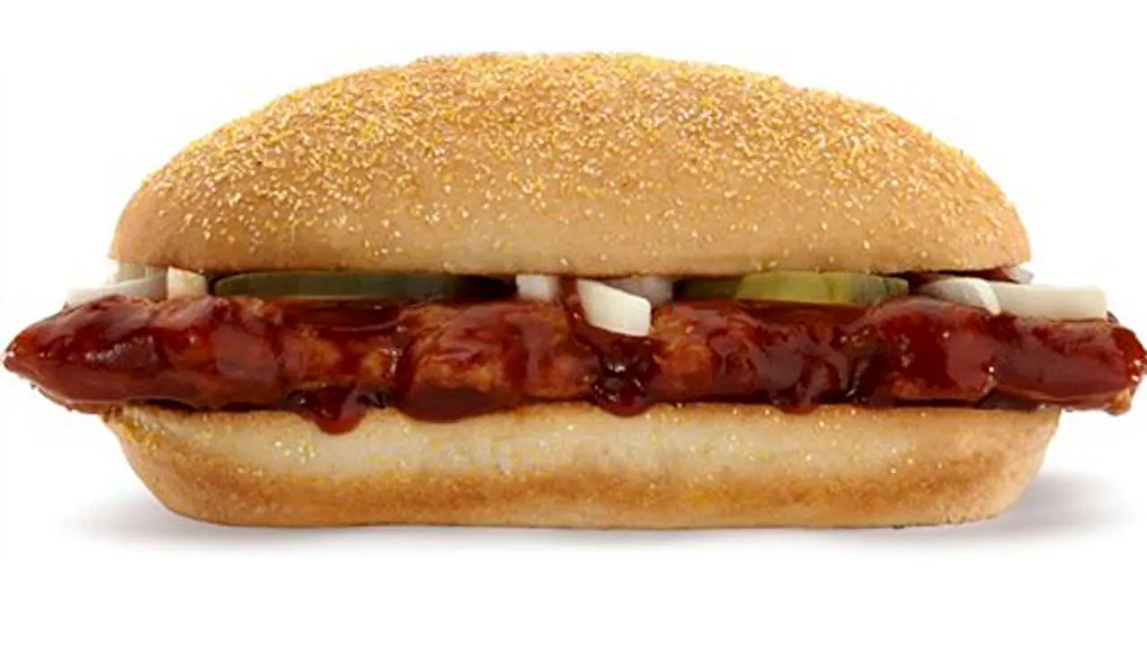 A McDonald’s McRib sandwich with barbecue sauce, onions and pickles on a soft bun.