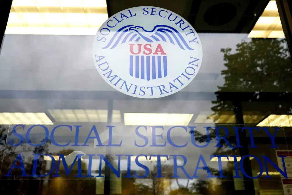 A Social Security card and U.S. currency illustrating the 2027 benefit adjustment