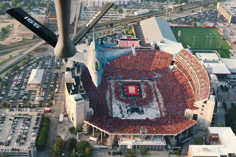 A KC-135 tanker and an F-16 fly over a packed Memorial Stadium in Lincoln, Nebraska, before a Nebraska volleyball match in August 2023