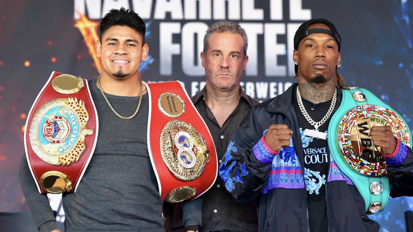 Emanuel Navarrete and O’Shaquie Foster pose with their championship belts at a press event before their super featherweight title fight