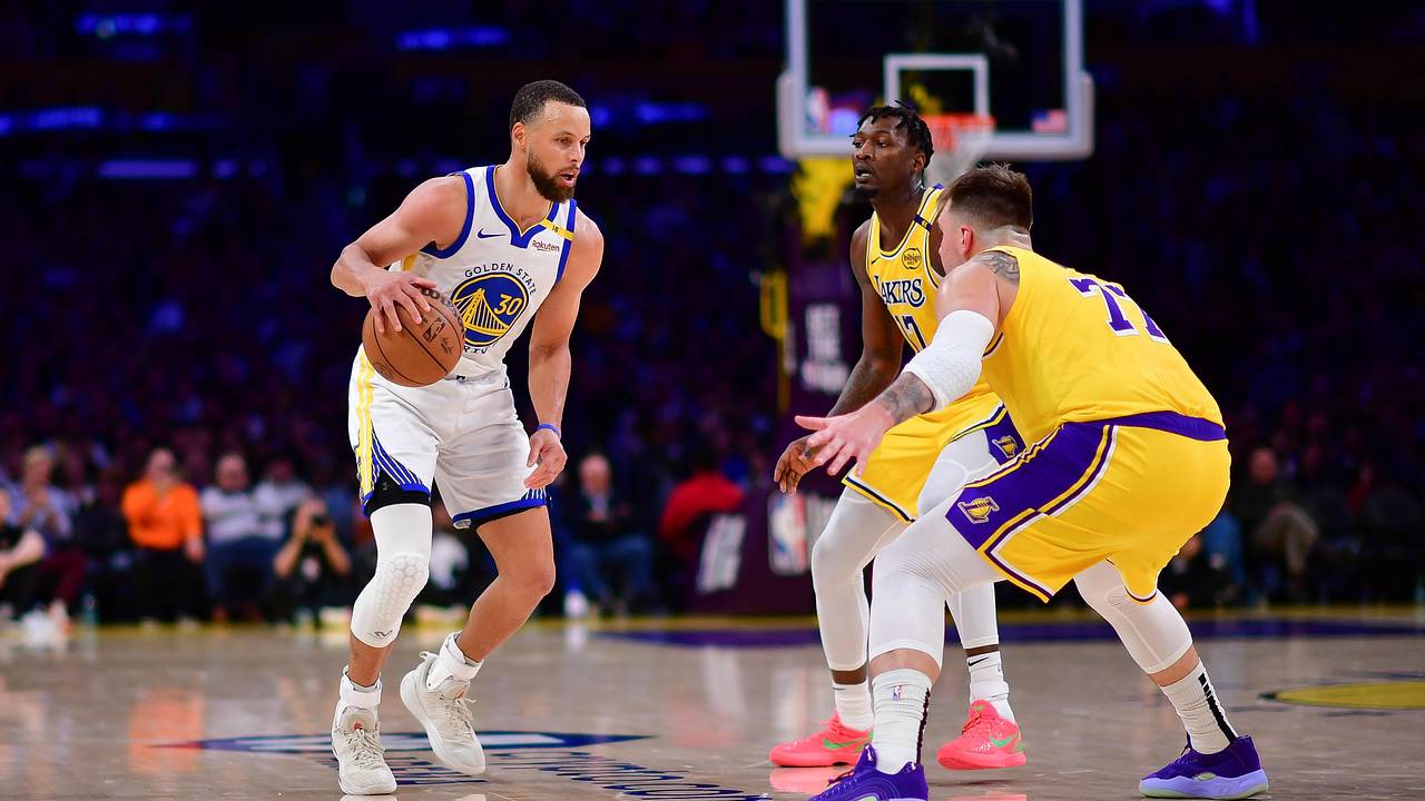 Stephen Curry dribbles against Luka Doncic during an earlier Warriors-Lakers game; archival photo, not the Oct. 21, 2026 game.