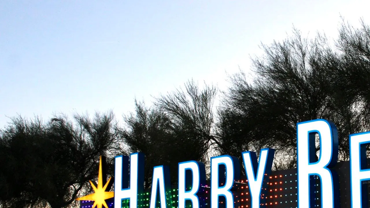 An illuminated Harry Reid International Airport sign outside the Las Vegas airport at night
