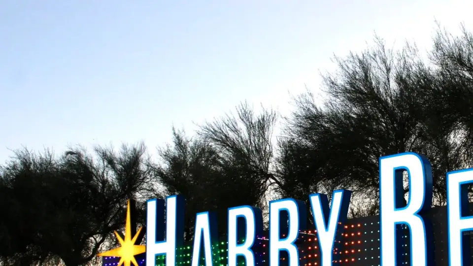An illuminated Harry Reid International Airport sign outside the Las Vegas airport at night