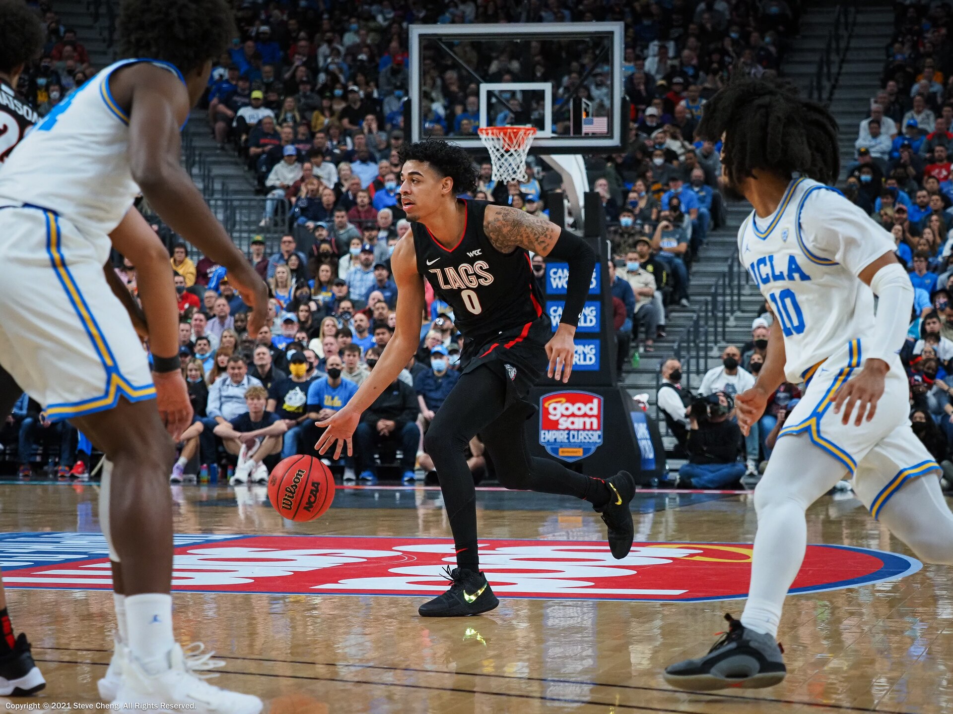 Julian Strawther, wearing a white Gonzaga uniform with the number 0, during a college game against UCLA in Las Vegas in 2021