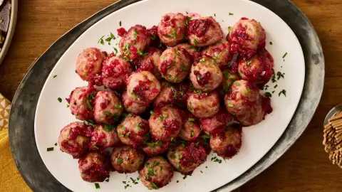 Turkey meatballs coated in glossy cranberry glaze and garnished with parsley