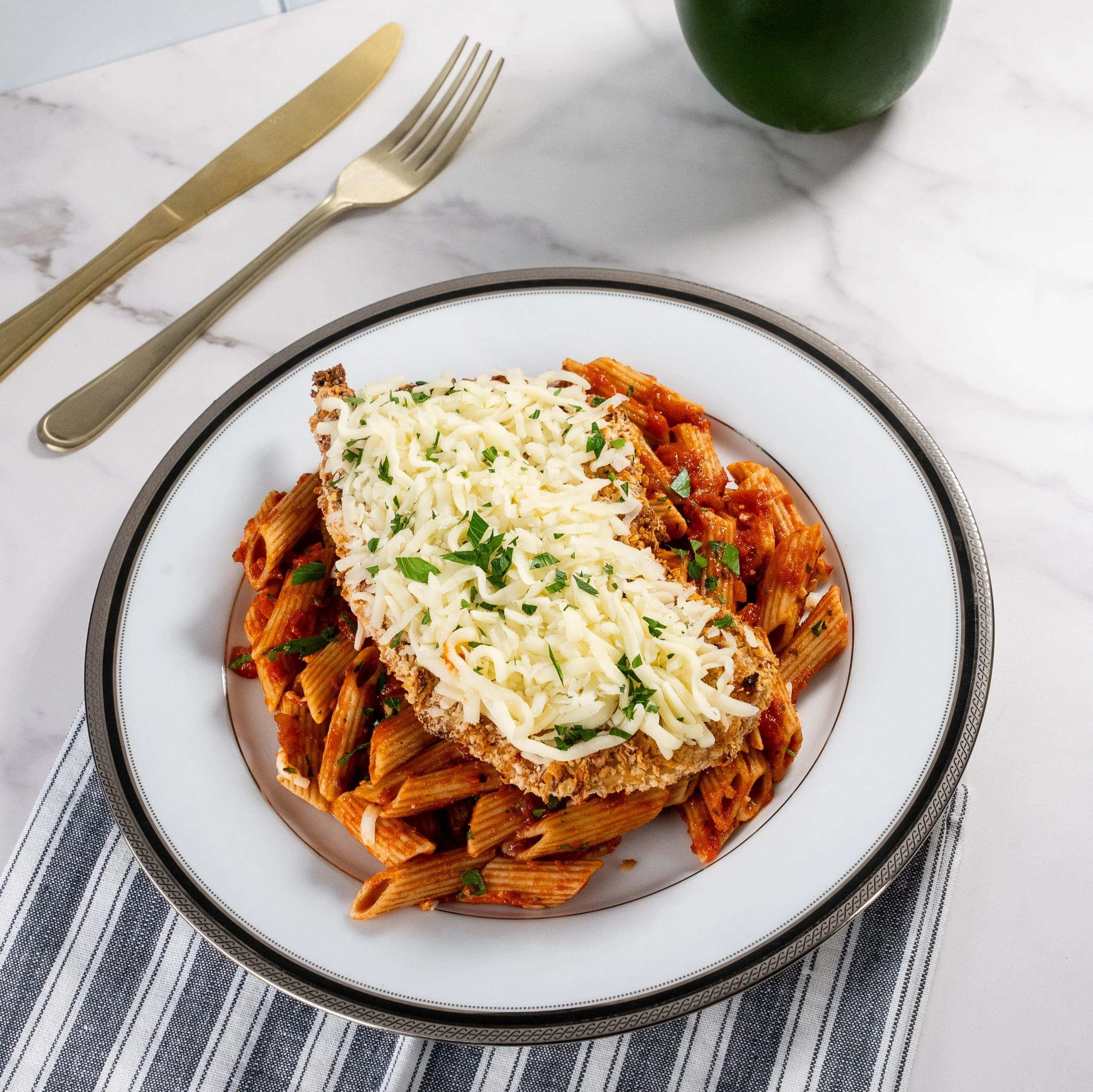 A prepared serving of lightened chicken parmesan pasta