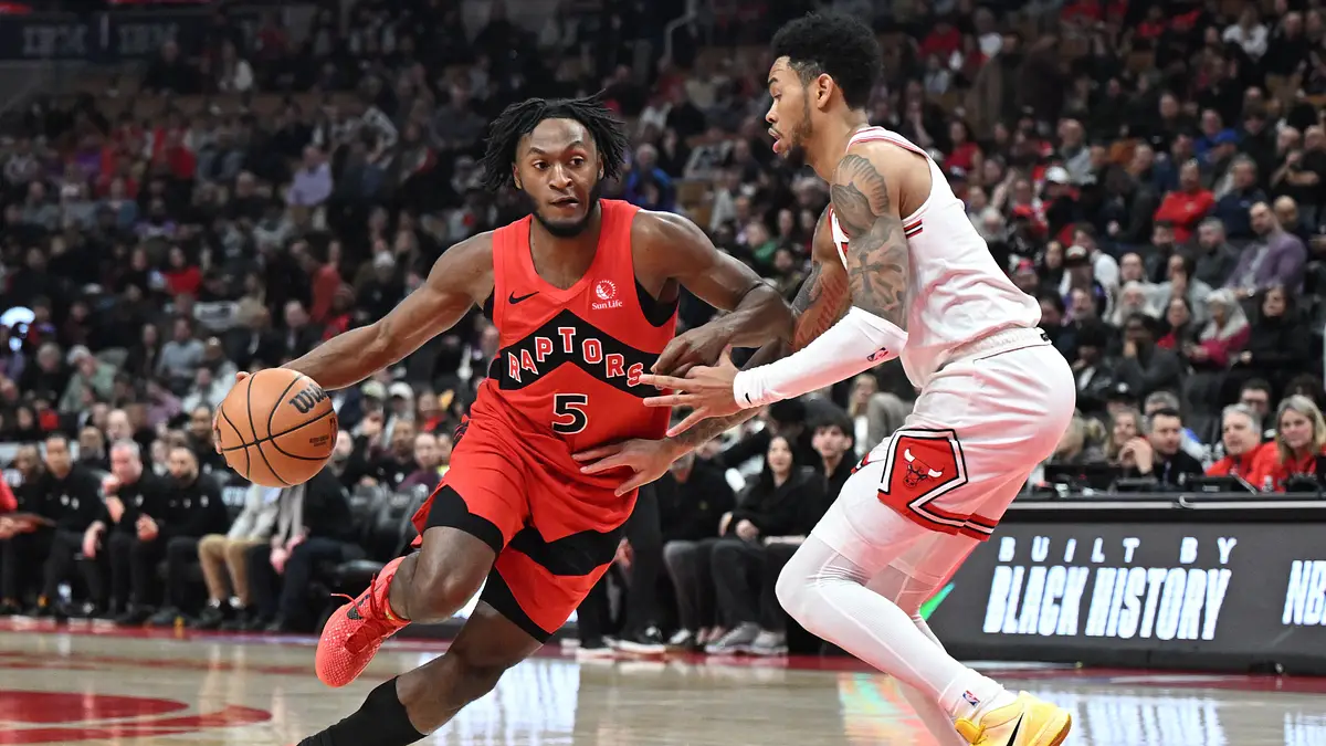 Toronto Raptors guard Immanuel Quickley drives past Chicago Bulls guard Anfernee Simons during a game at Scotiabank Arena.