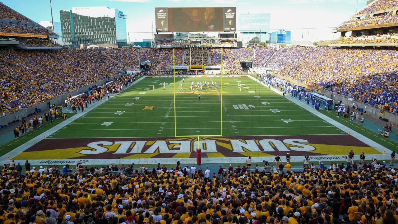 A college football game under way before a packed crowd at Mountain America Stadium in Tempe, Arizona