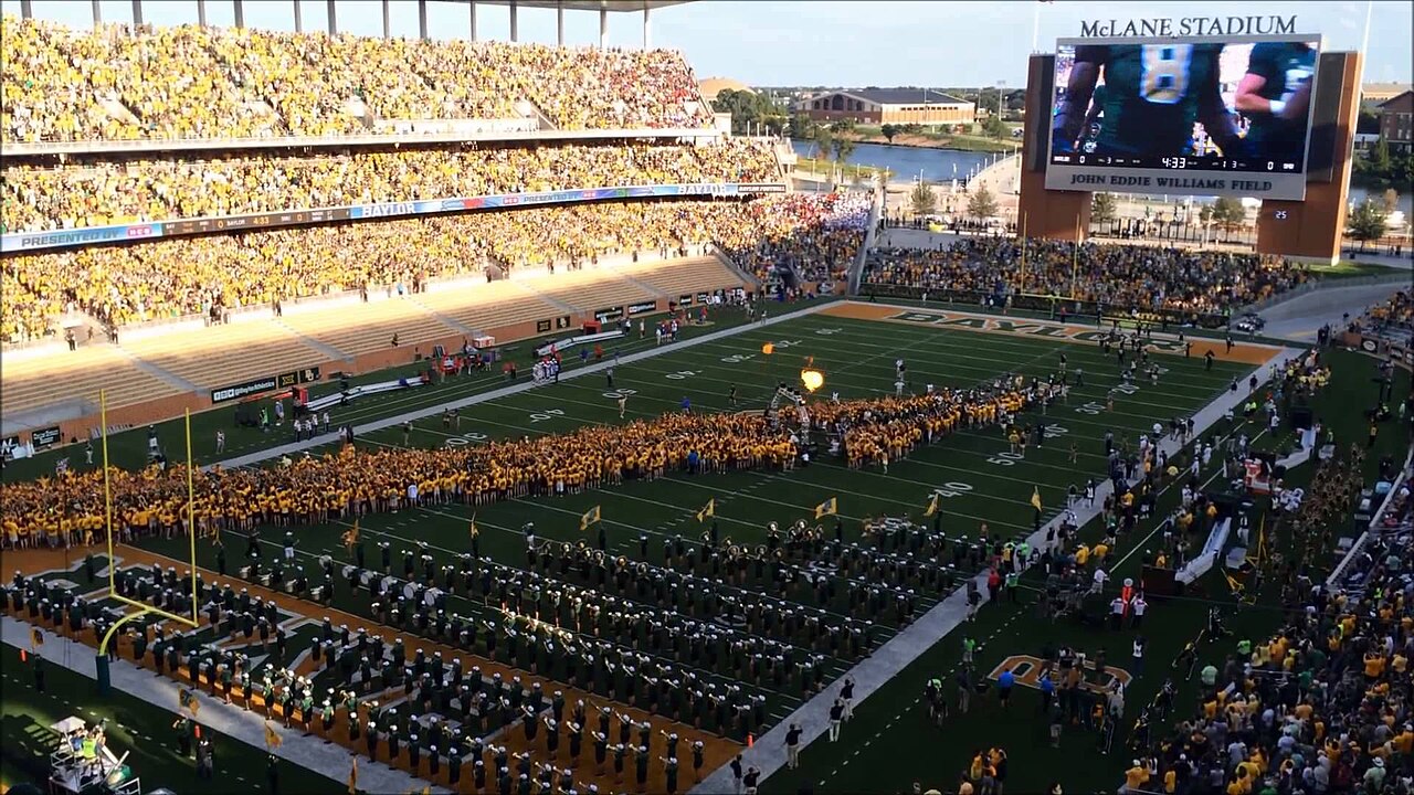 Baylor students form a tunnel on the field before a home football game.