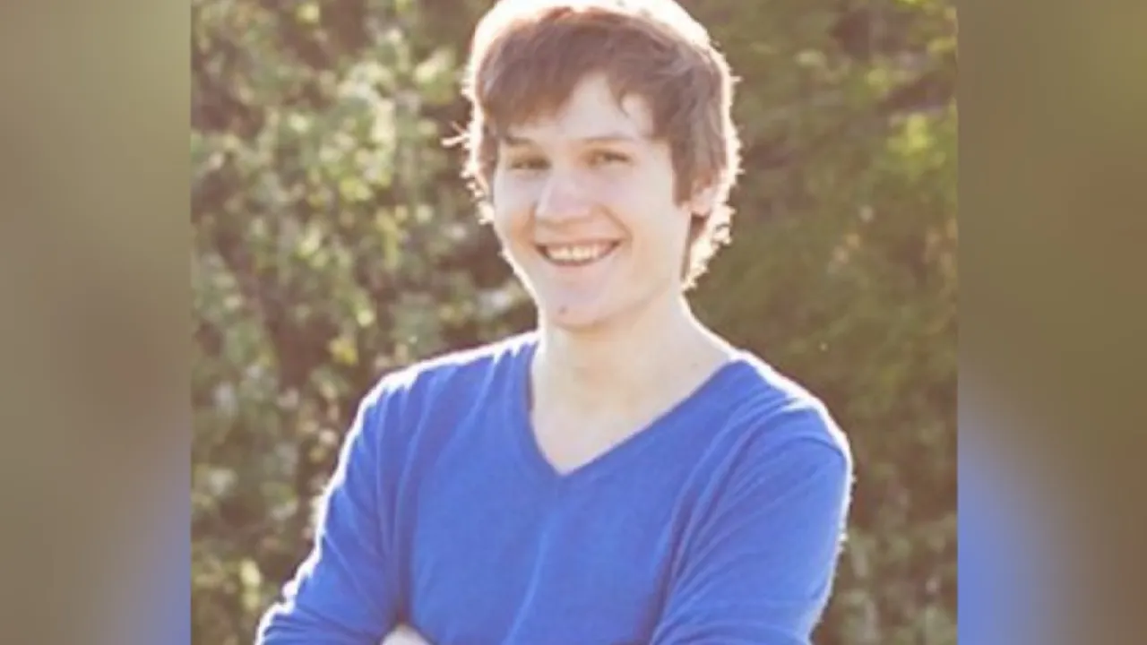 An archival portrait of Stick Run creator Manuel Otto smiling outdoors in a blue shirt.