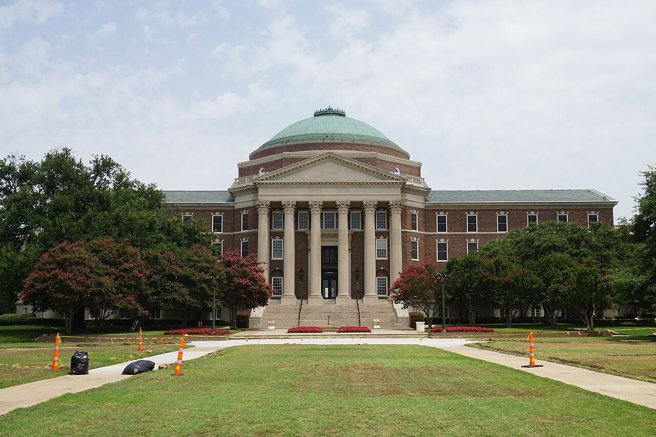Dallas Hall, the domed brick building at the center of Southern Methodist University's campus, seen across a lawn in July 2016