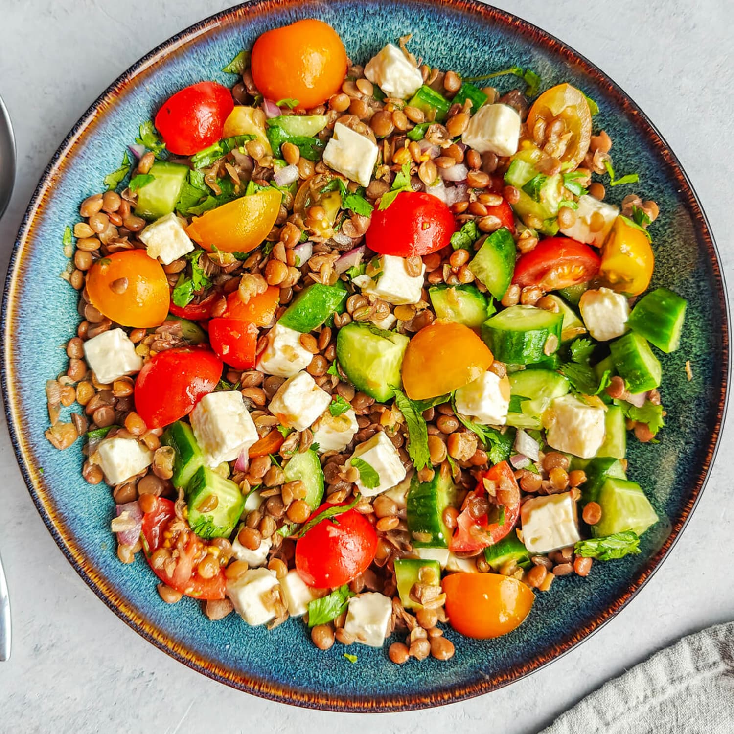 A prepared serving of lentil, cucumber and feta salad